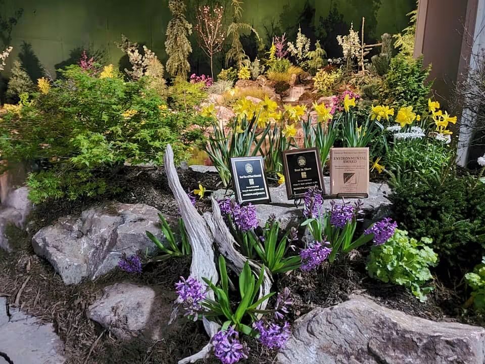 Award plaques set among daffodils and hyacinths in a show garden display