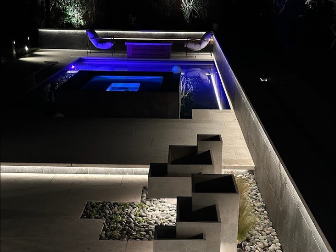 Plaza Midwood floating limestone planters and pool, underlit at night
