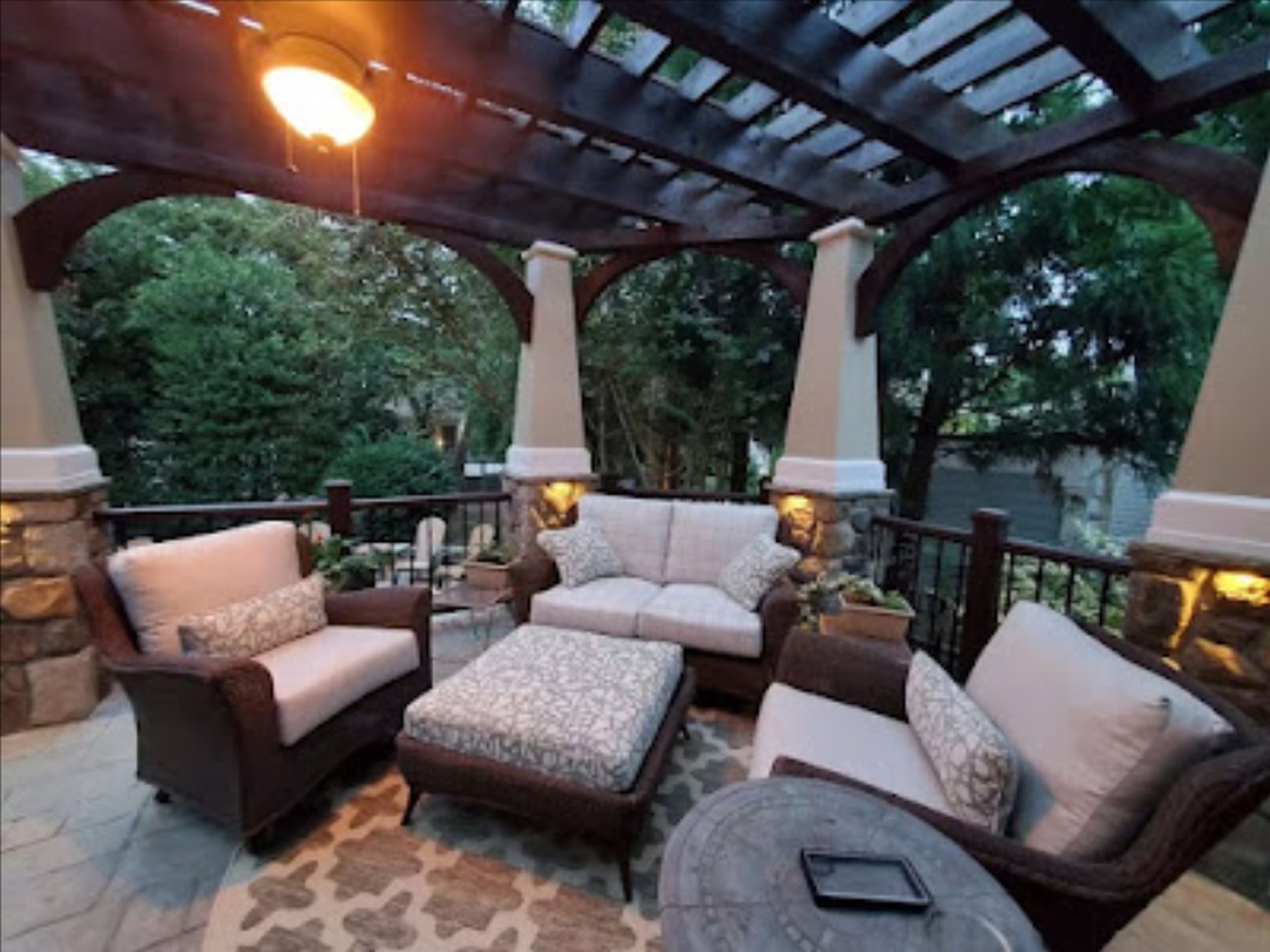 Pergola-covered outdoor living space furnished for evening use