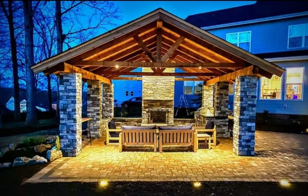 Rustic timber pavilion with river-rock fireplace and garden