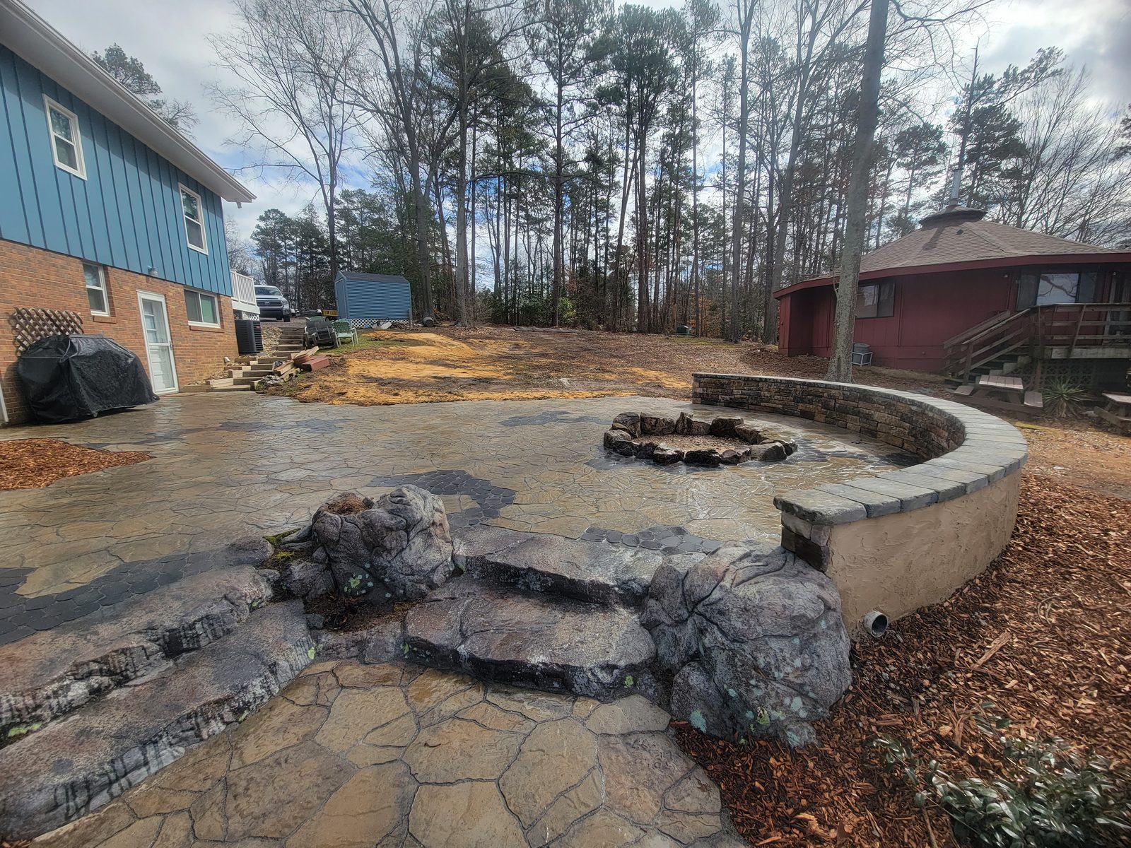Fire pit with natural boulder steps at Lake Tillery