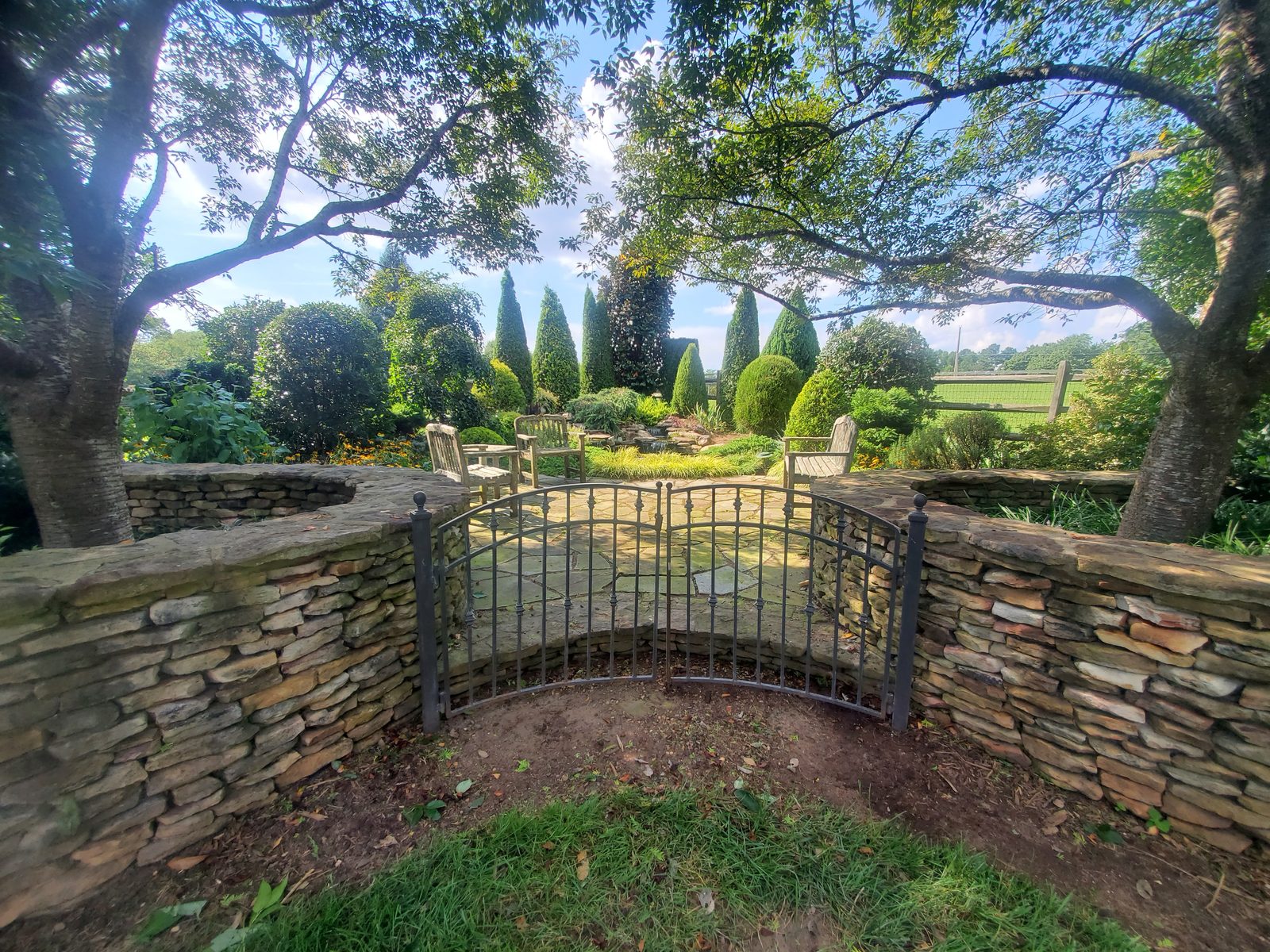 Stacked-stone wall and iron garden gate at Lake Wylie