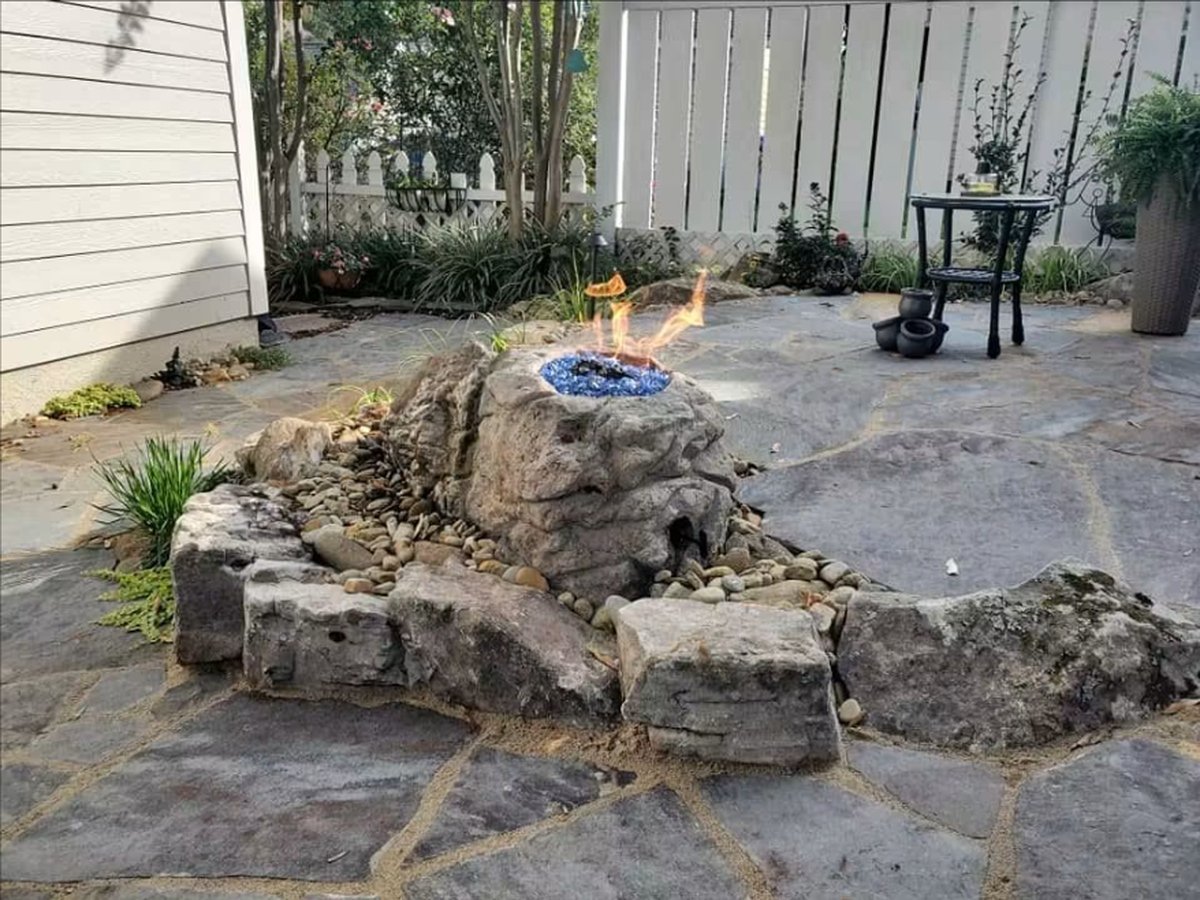Flagstone patio with a boulder fire feature